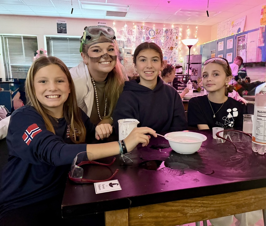 students and science teacher making slime