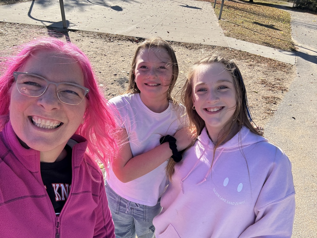 pink haired principal with students on the pplayground