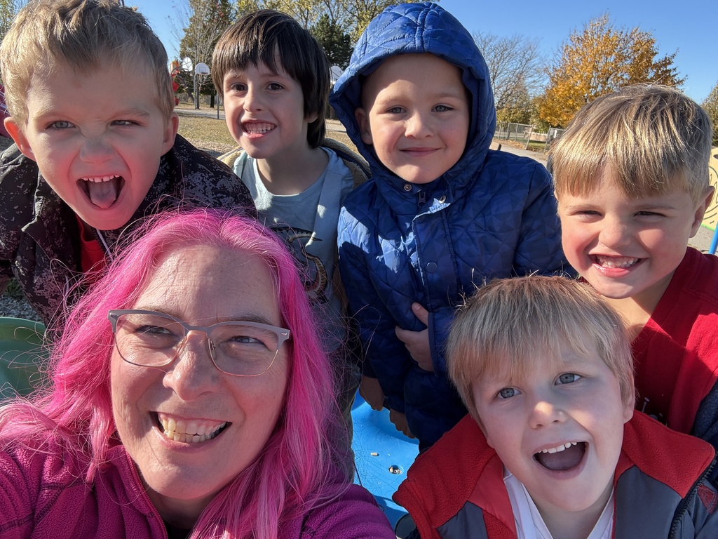 Pink haired principal with students on the playground