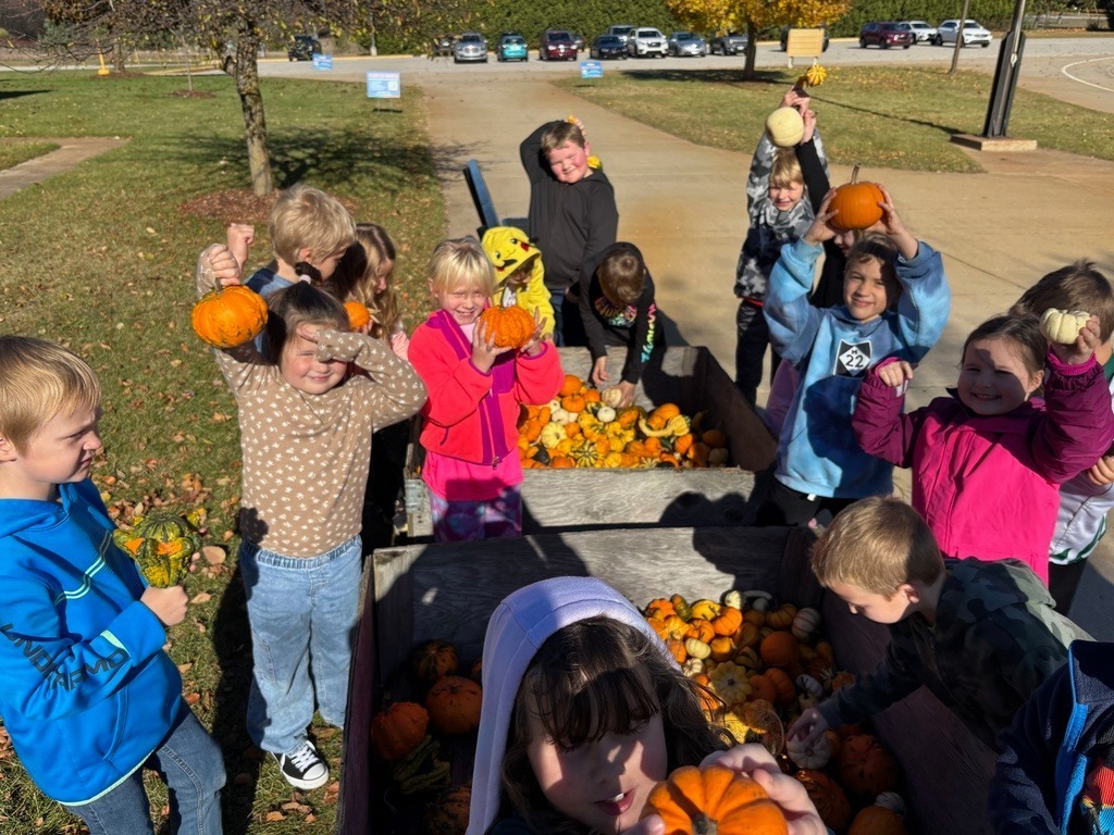childrern holding pumpkins