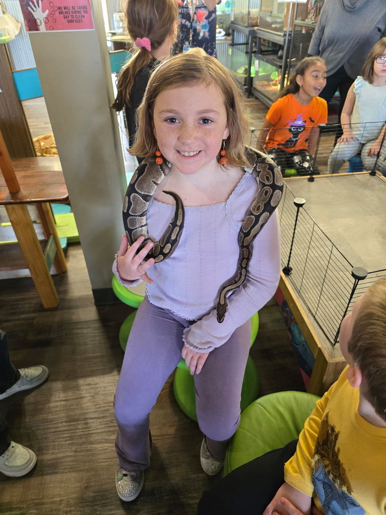 Student with snake around her shoulders