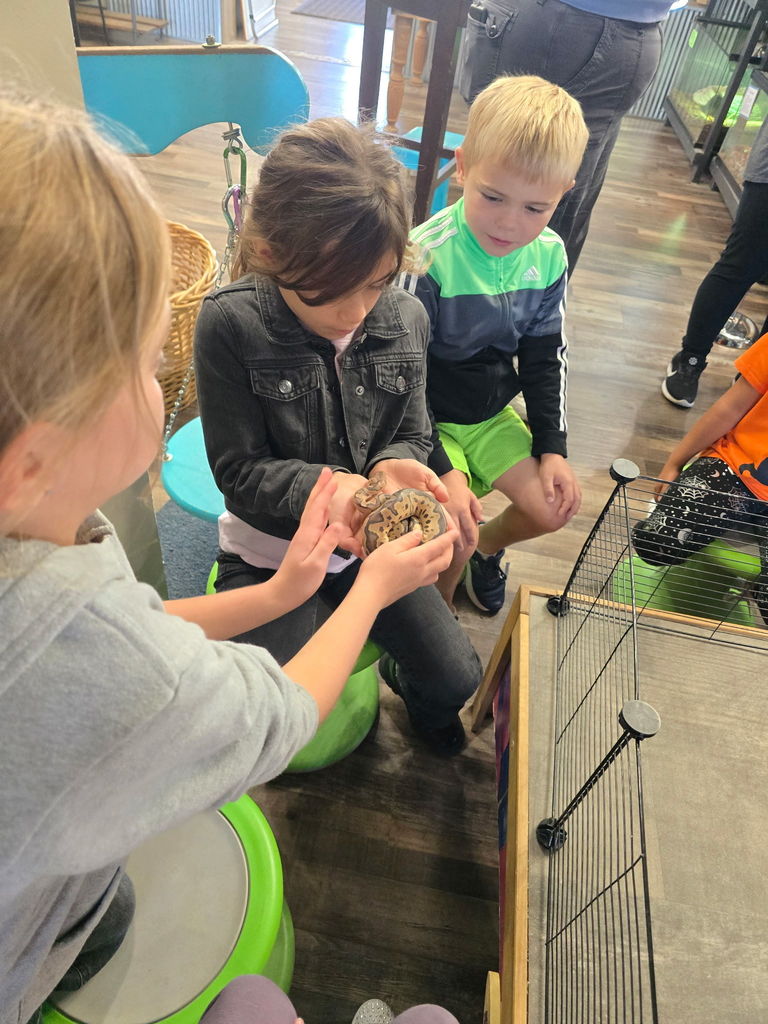 Student holding snake in hand