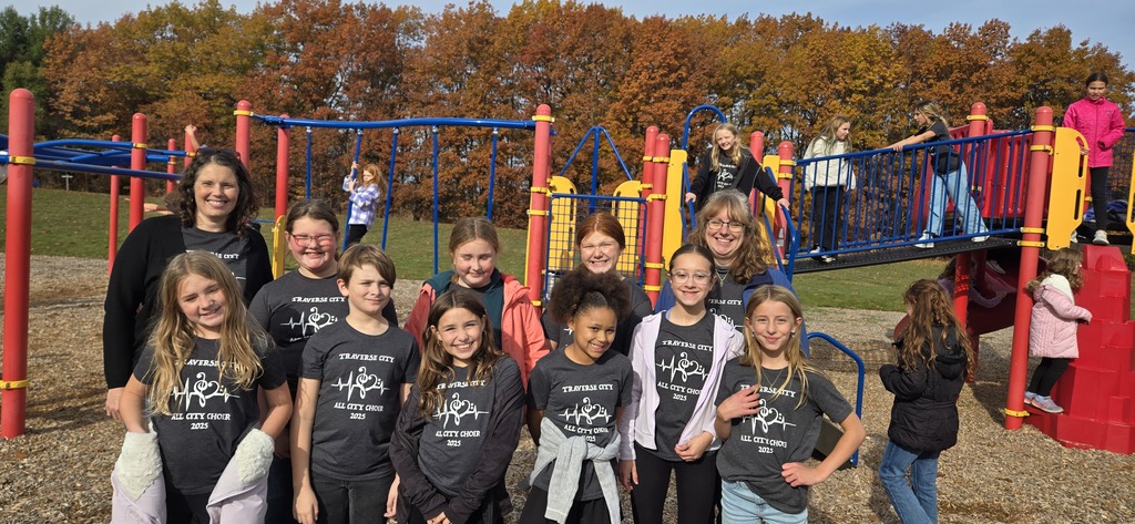 All City Choir students standing for a photo in front of the play structure with Mrs. Harrod- Burch and Mrs. Wiiliford