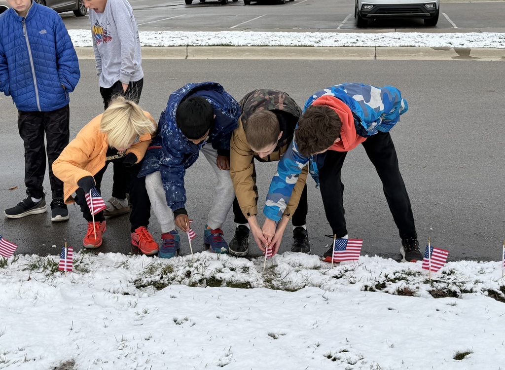 Students placing American flags around the front circle.