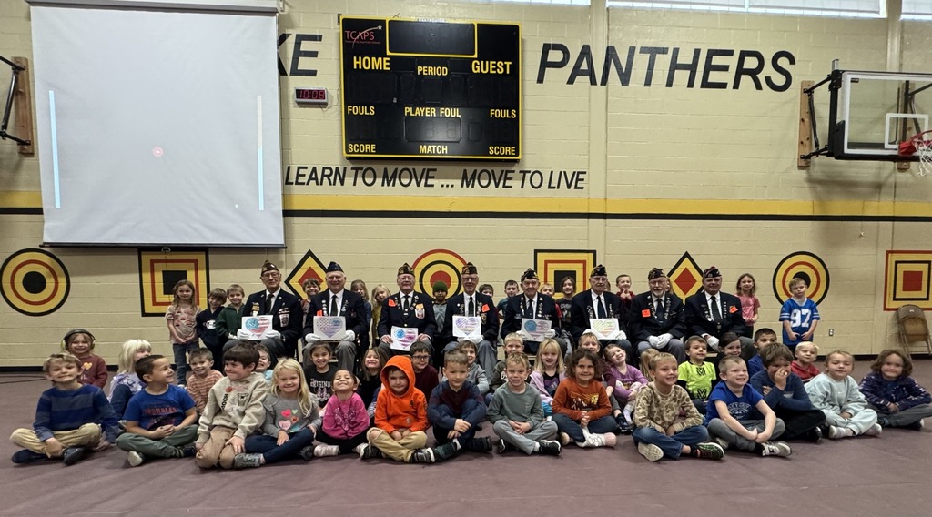 students and veterans sitting in the gym