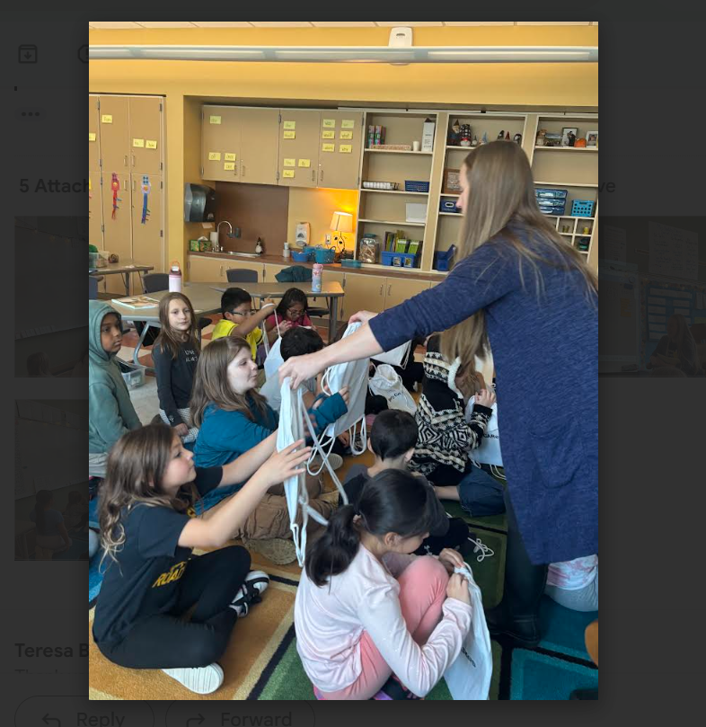 teacher handing students book bags