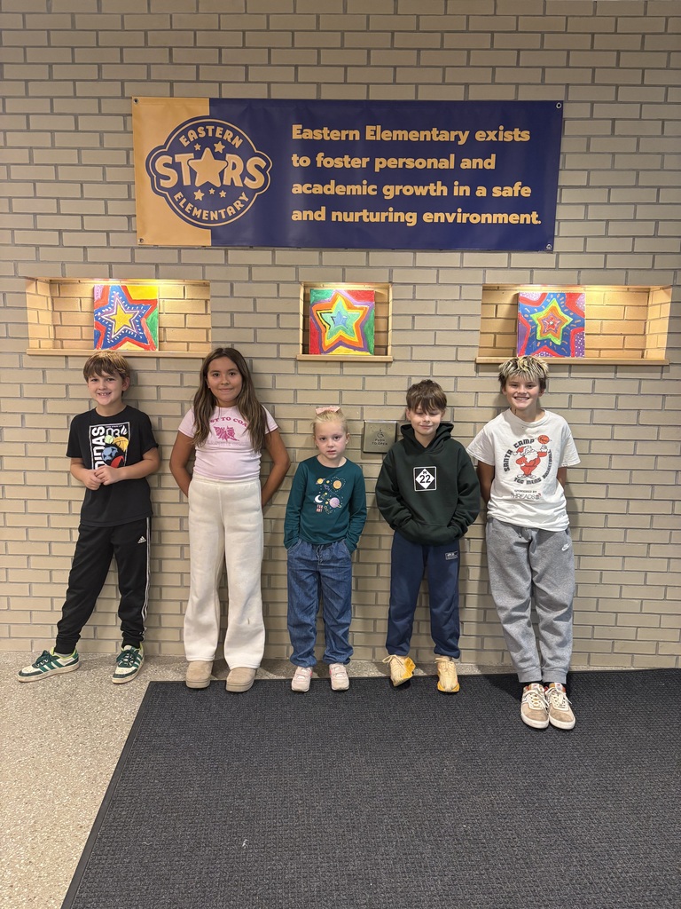 Five star students standing against a wall