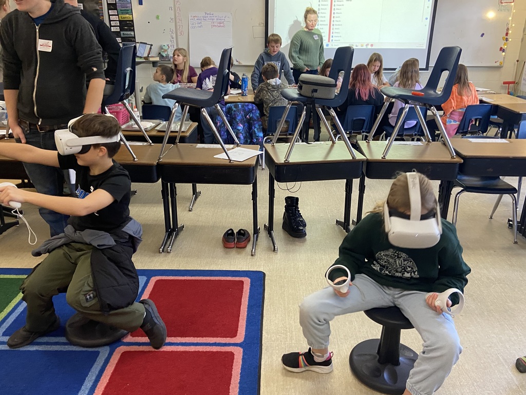 A student sitting on a black wobbly chair using a vr headset
