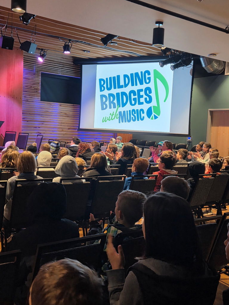 audience looking at a Building Bridges with Music sign 