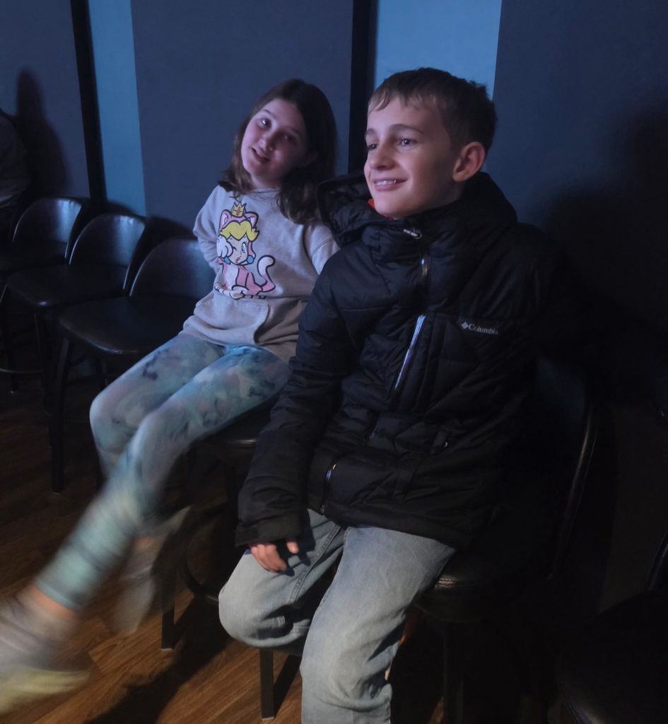 Two students smiling while listening to music