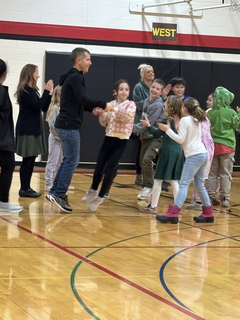 A dad and his daughter holding hands as they dance through people on both sides