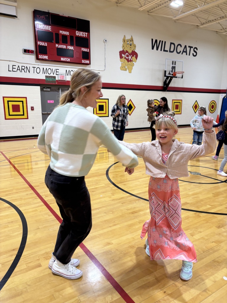 A mother and a girl  doing the do se do