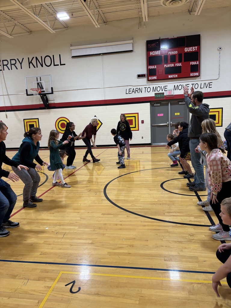 Two lines of people facing a pair of students dancing between the line