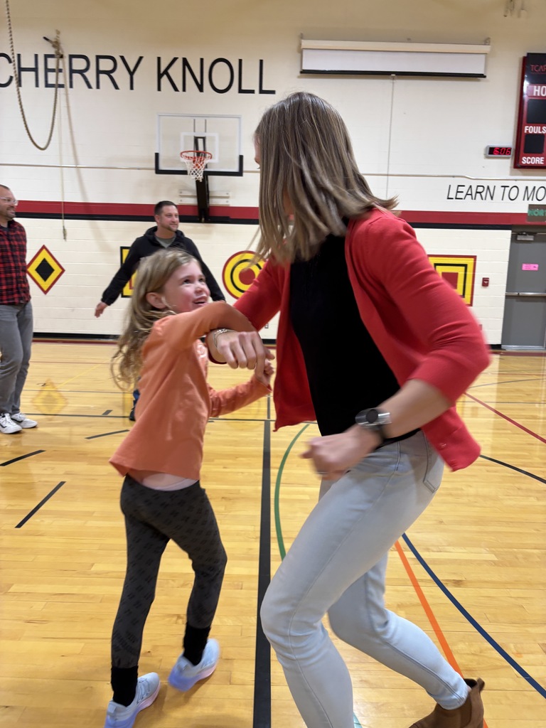 A mother and a girl  doing the do se do