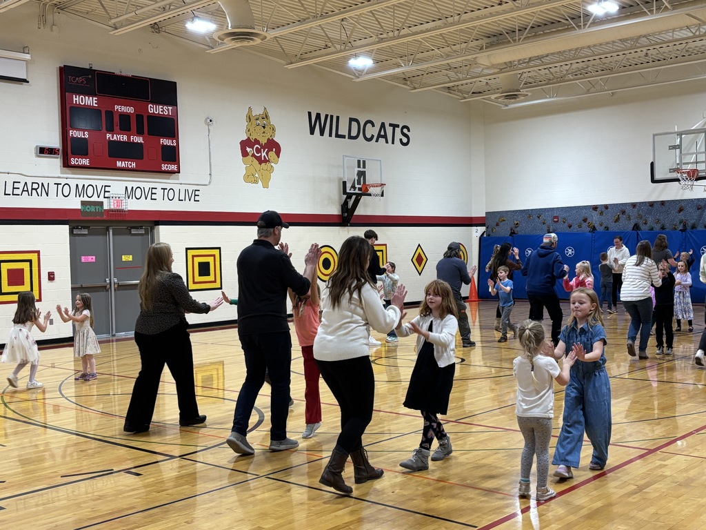 Pairs of people touching palms as they dance