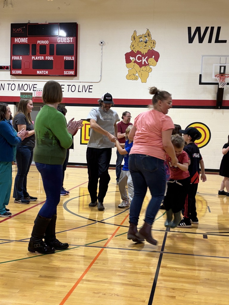 Parents and students  holding hands dancing 
