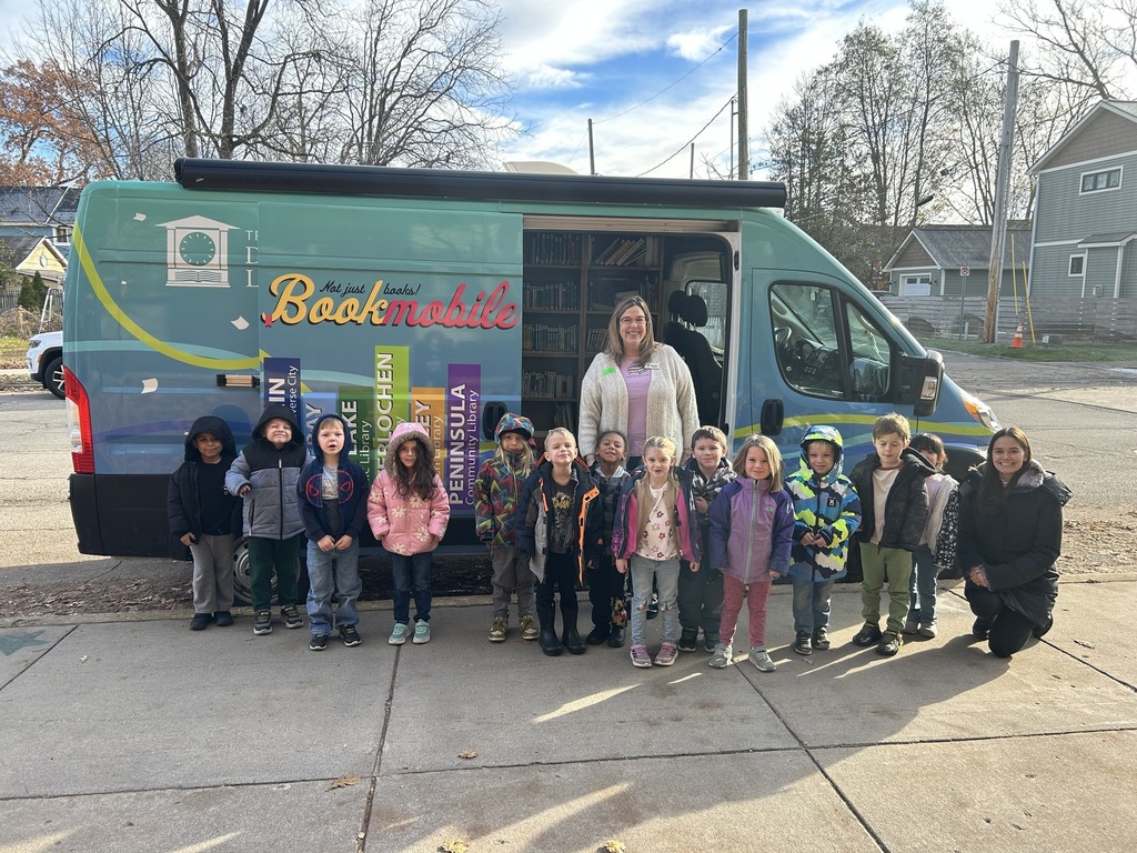 Students standing in front of the library book mobile