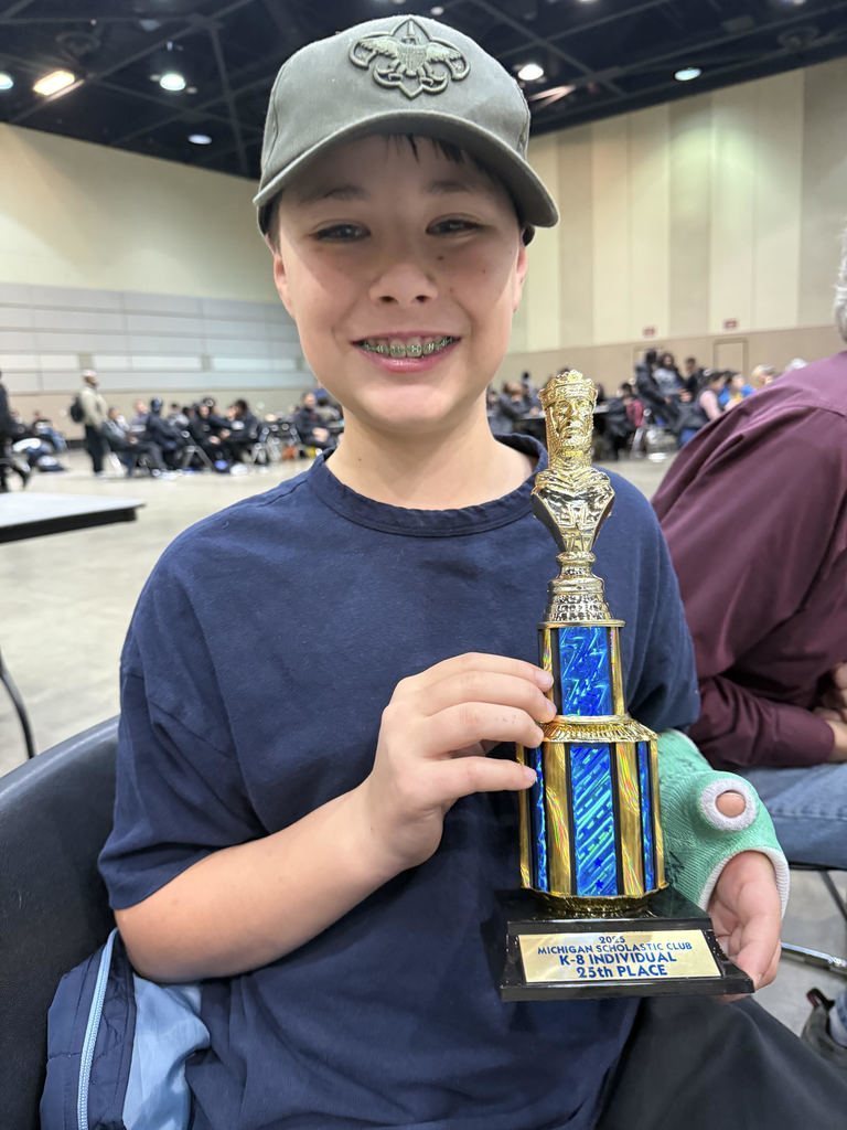 Student holding a trophy