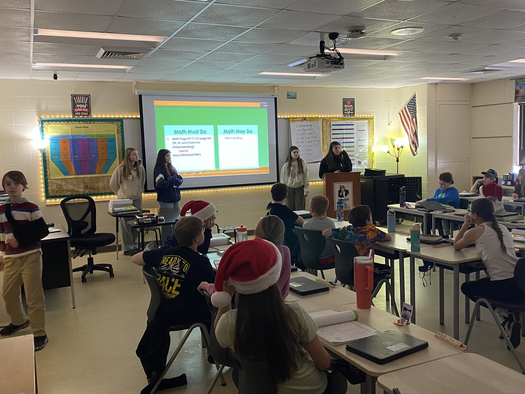 High school students speaking to a classroom of students sitting at their desk