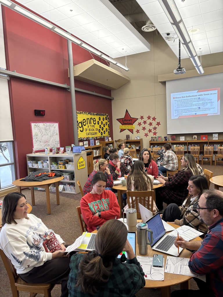 teachers sitting around tables talking