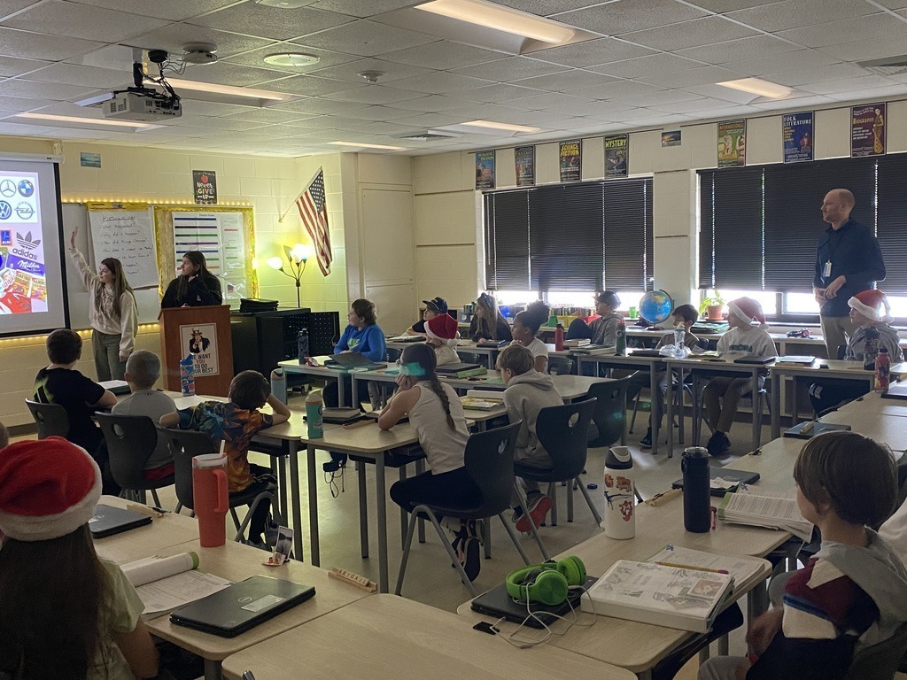 Students sitting at desk looking at a screen