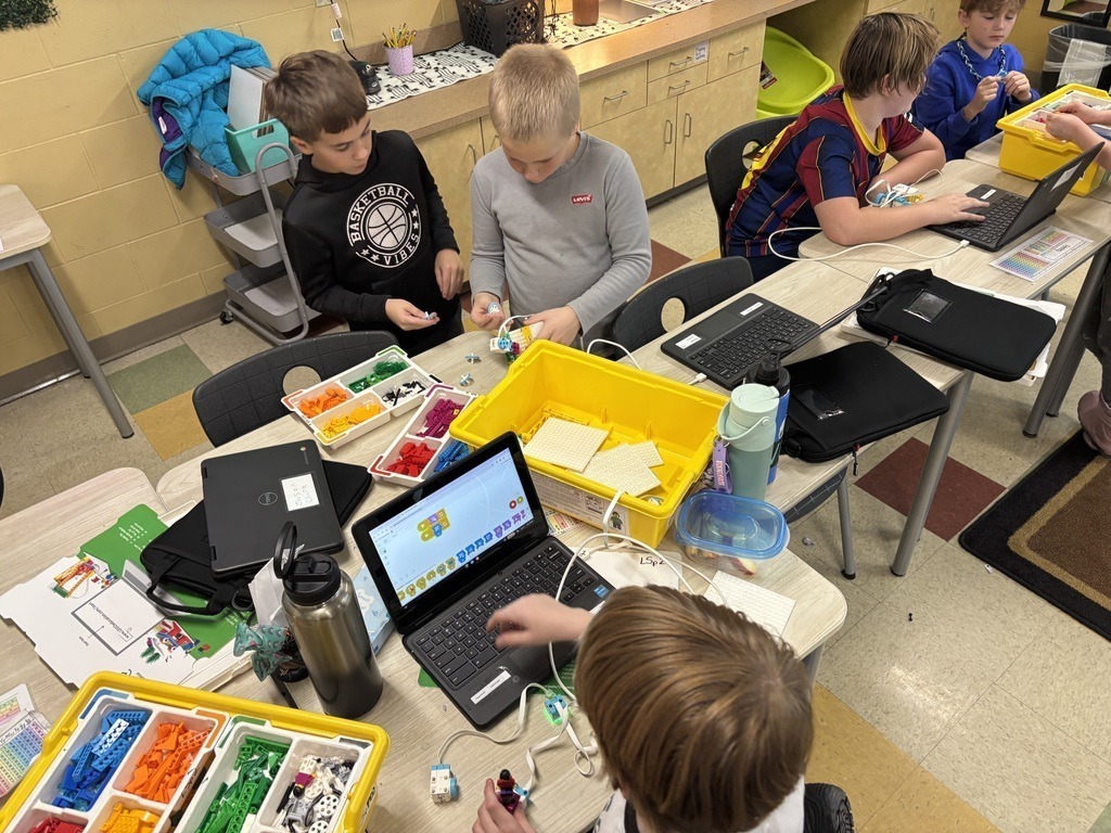 students sitting at desks working on their Exploreres Program