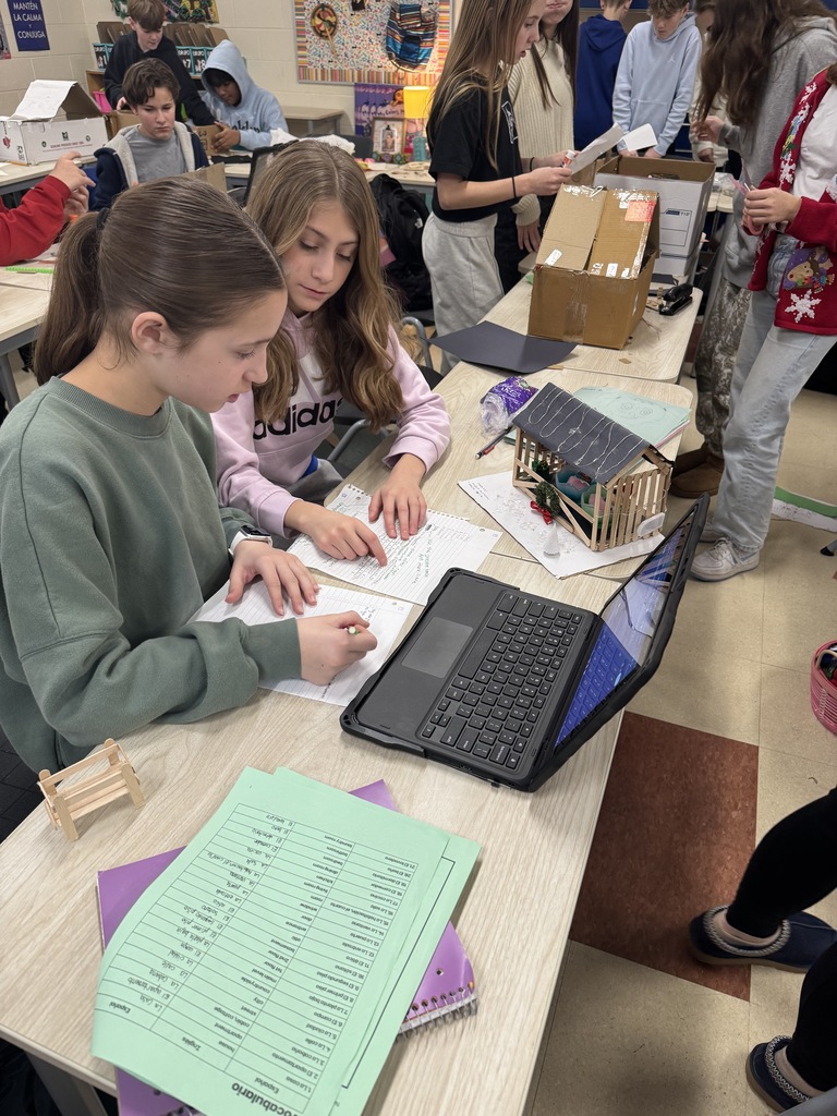 Students in spanish class working on home decorating in Spanish.