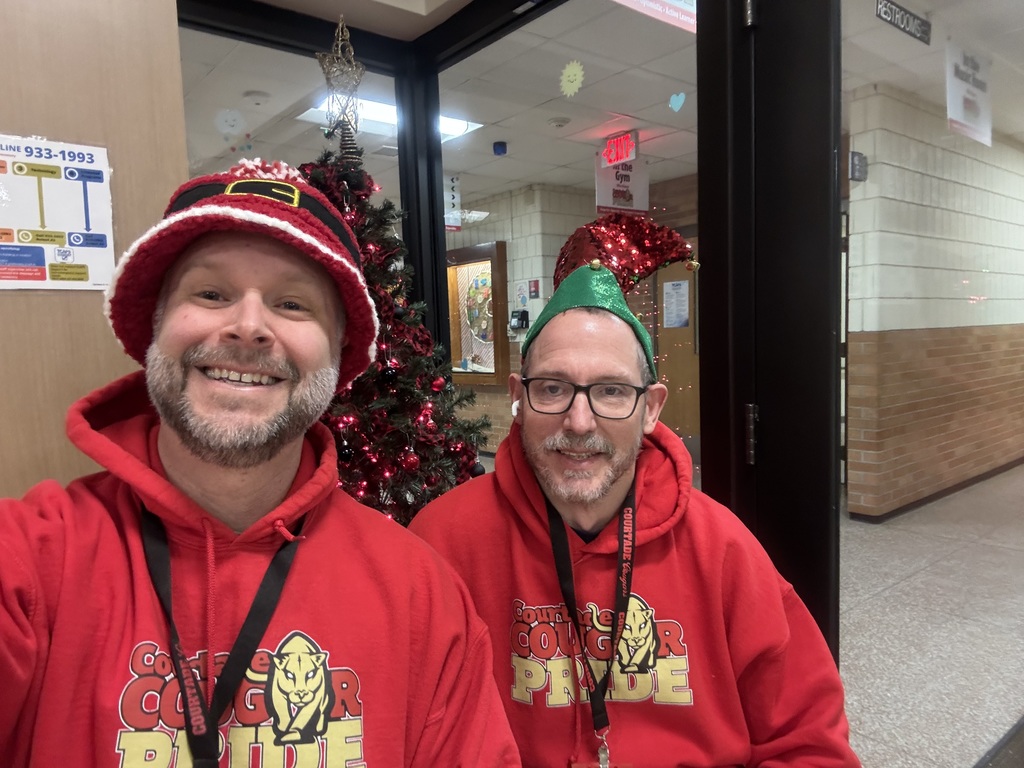 Mr. Rob and Mr. Phillips matching shirts and holiday hats.