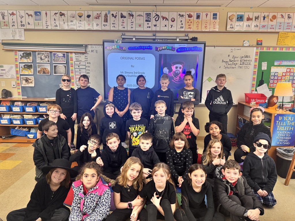 students sitting on floor in black clothing