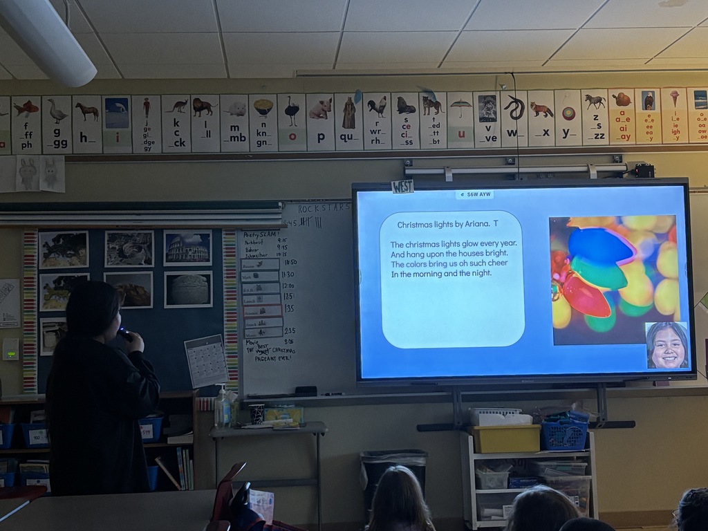Student reading a poem that is displayed on the projector