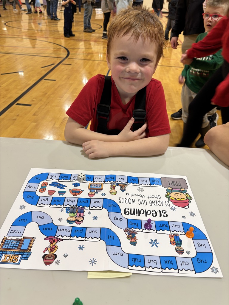 Smiling student in front of gameboard