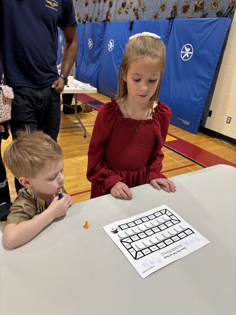 a boy and girl looking at a game board