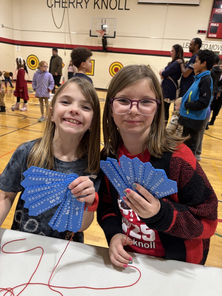 Two girls holding a math string activity