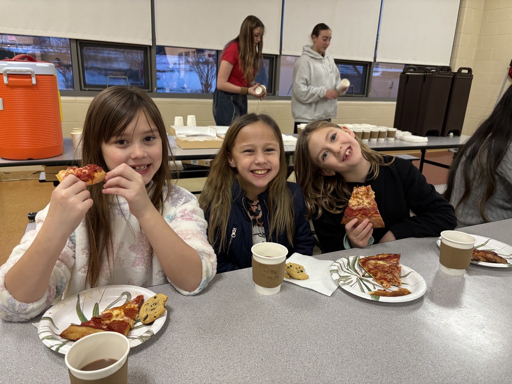 Three girls eating pizza