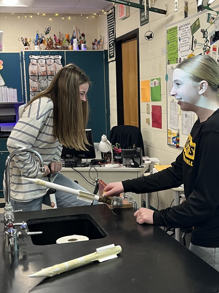 students in science class launching air propelled rockets.