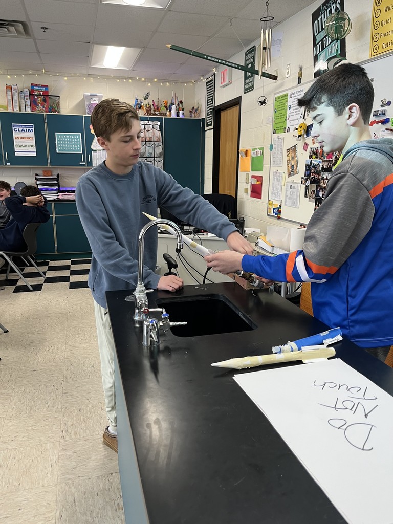 students in science class launching air propelled rockets.