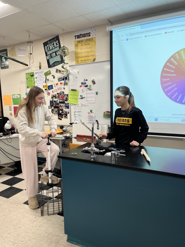 students in science class launching air propelled rockets.