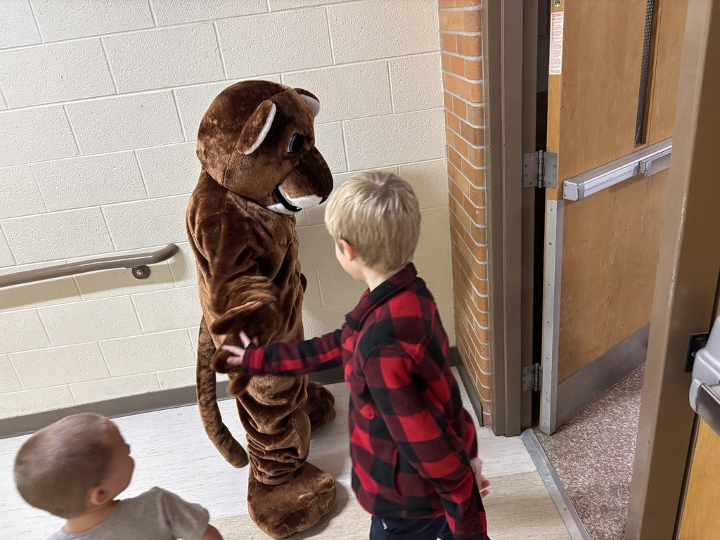 ROARY high fiving a kid.
