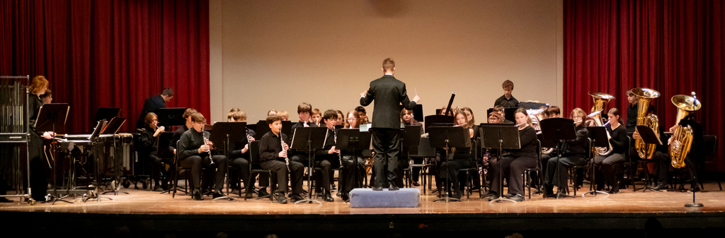 group photo of our 8th grade symphony band performing at Lars