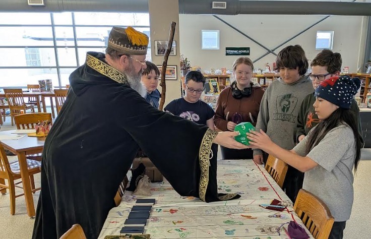 Dungeons and Dragons guest showing club students dice and and other goodies