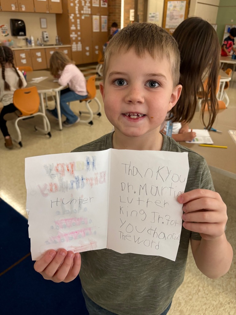 Blair elementary student holding a card he made for Martin Luther King Jr.