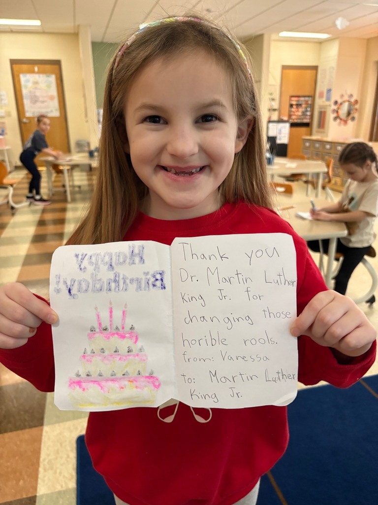 Blair elementary student holding a card she made for Martin Luther King Jr.