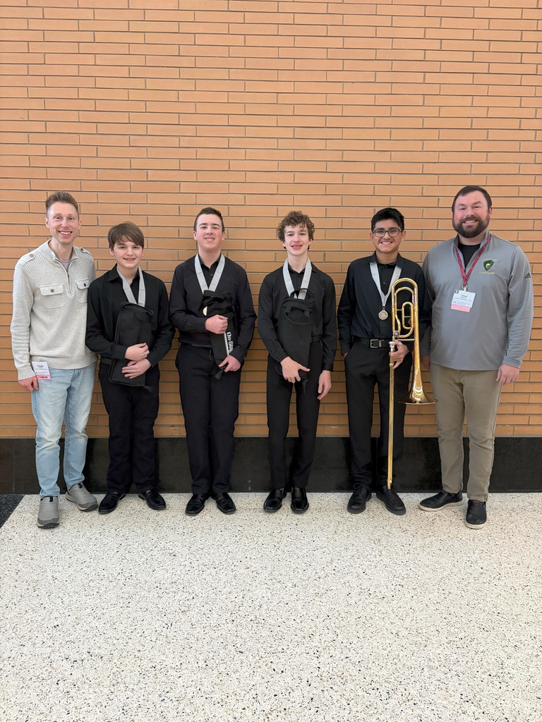 Two instructors and four students in formal black attire with All-State medals posing against a brick wall.