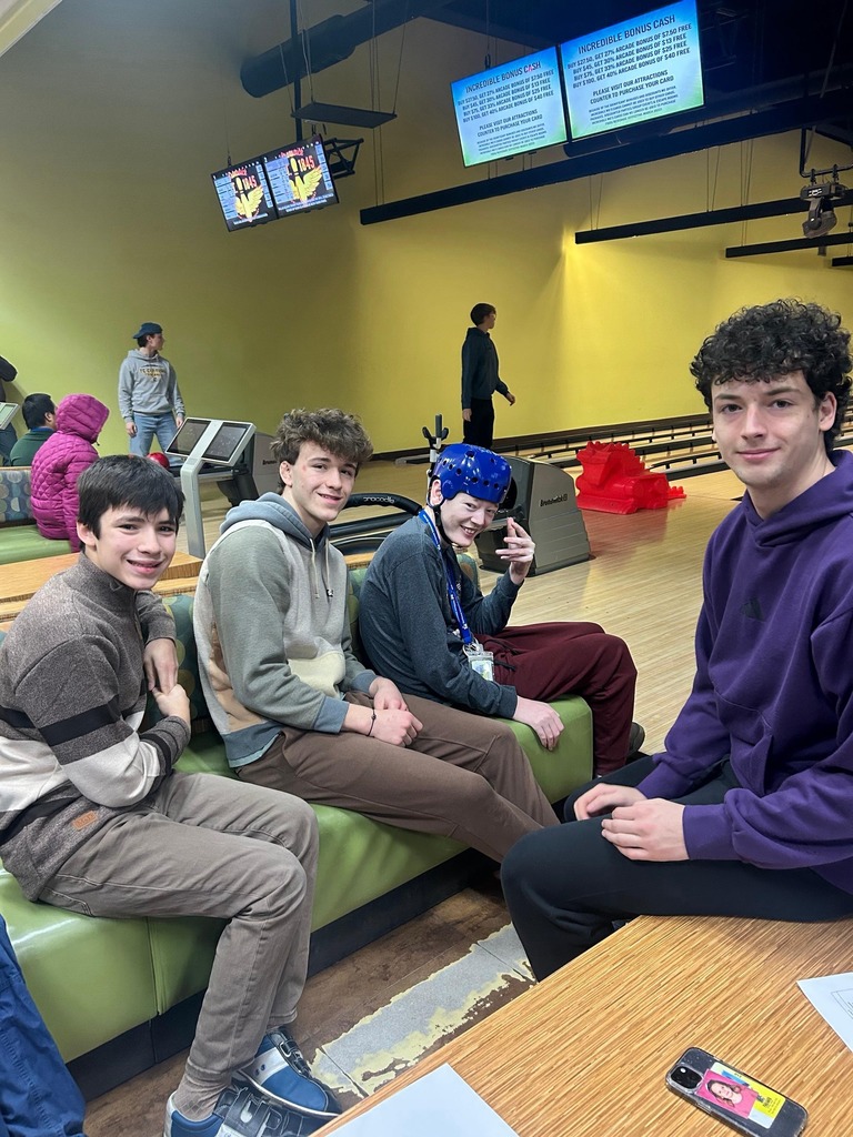 Students sitting  inside Incredible Moes for bowling