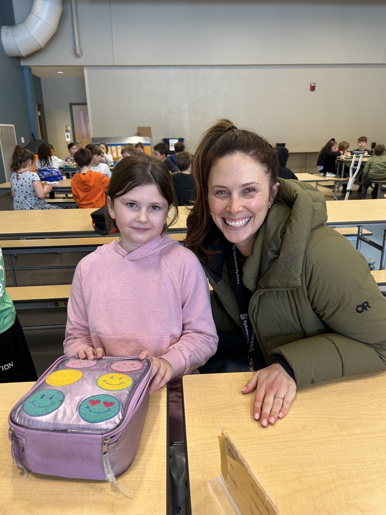 Volunteer from Big Brothers, Big Sisters  Organization sitting at a desk with a student