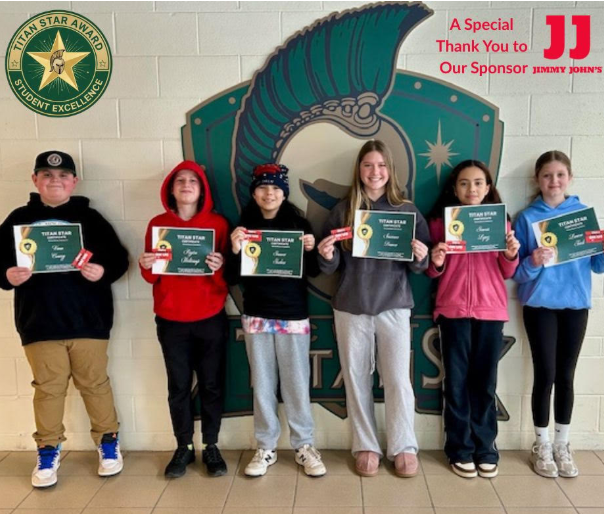Titan Star group of students holding certificates while standing in front of our Titan logo