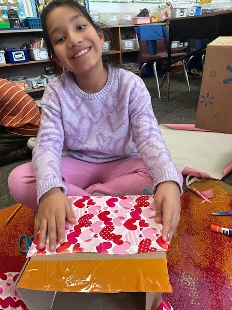 Student wrapping her Valentine box
