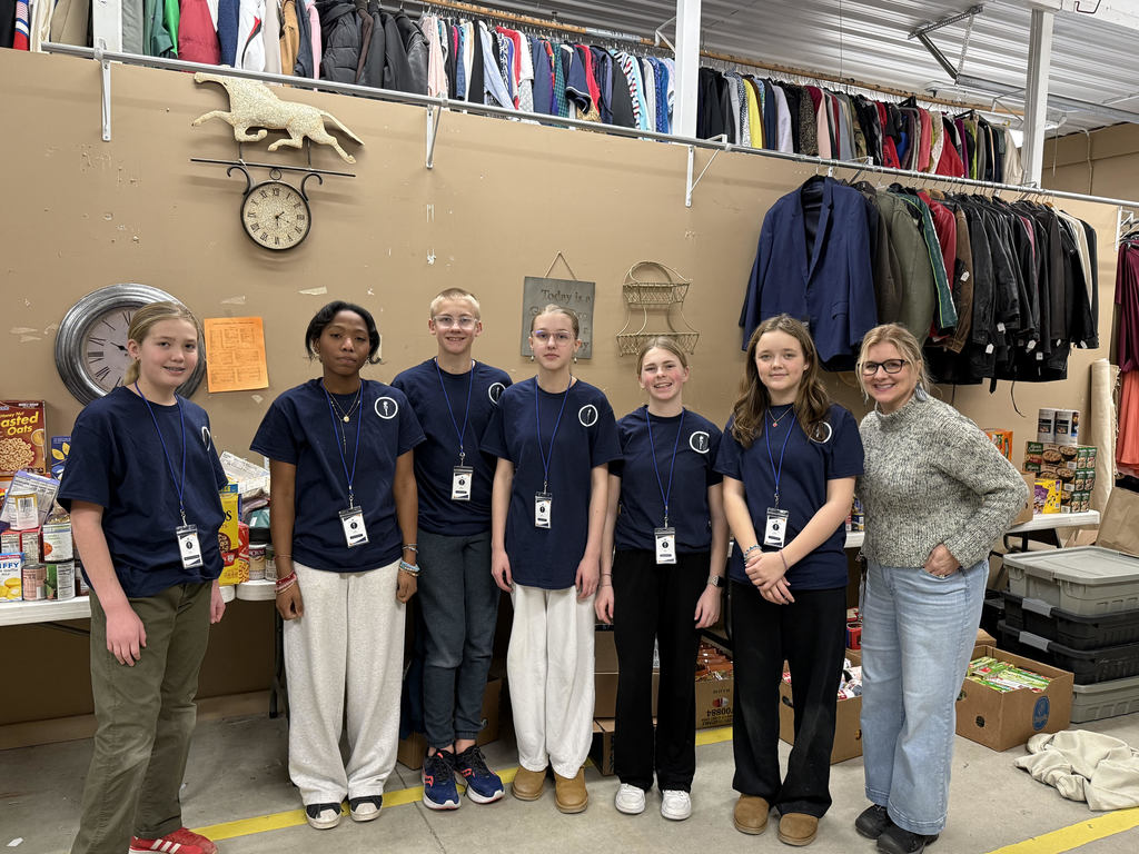 National Junior Honor Society students standing with their donations