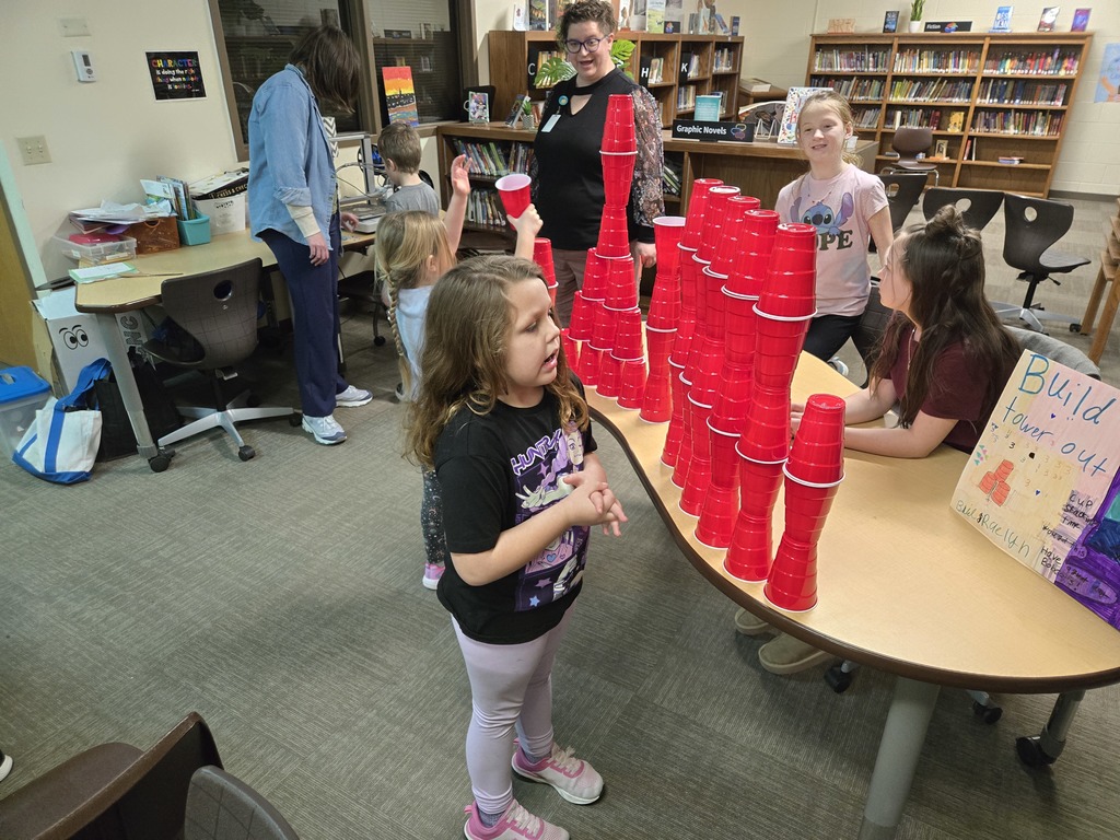 students looking at the different exhibits on the tables