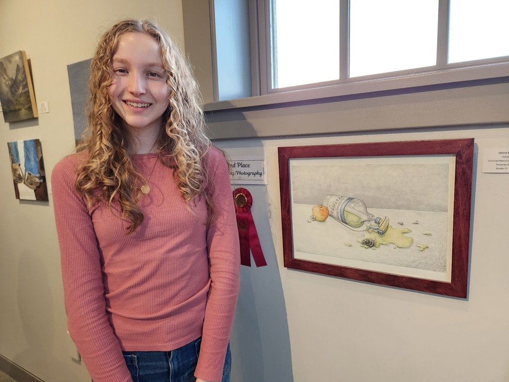 Photo of West Senior High art student standing in fron of her are project